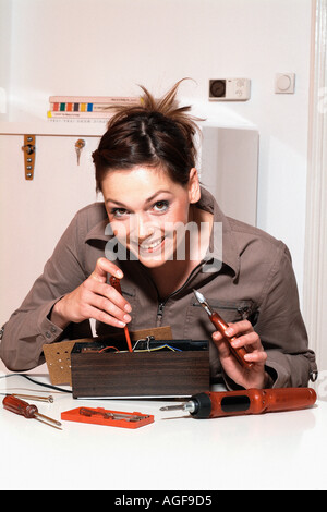 Young woman with fuse-box Stock Photo