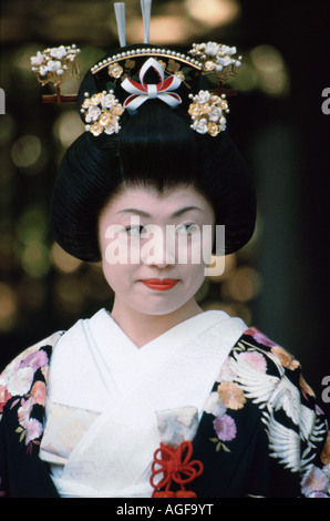 Japanese bride wearing traditional kimono wedding gown smiles just after getting marryied at the Meiji shrine, Tokyo, Japan Stock Photo