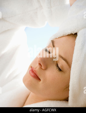 Caucasian mid adult woman wearing towel on head with eyes closed relaxing Stock Photo