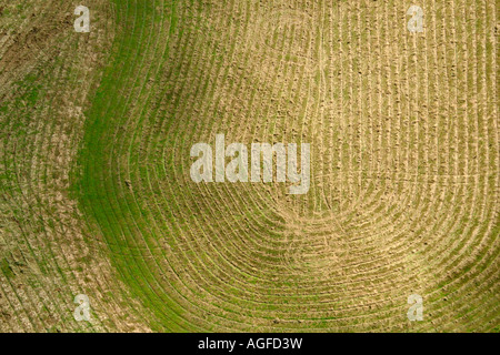 Aerial shot of patterns in a field left by farm machinery Stock Photo