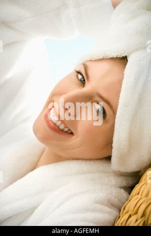 Caucasian mid adult woman wearing towel on head smiling at viewer Stock Photo