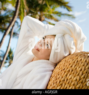 Caucasian mid adult woman wearing robe and towel on head with hand to head Stock Photo