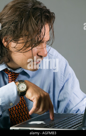 Young Latino businessman working on laptop computer Stock Photo