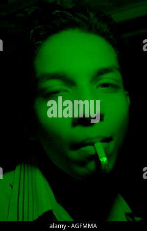 Teenager seen smoking a cigarette and passed out at a trance party Stock  Photo