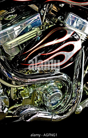 Low angle side view picture of a custom built motorcycle showing chrome exhaust pipes and engine Stock Photo