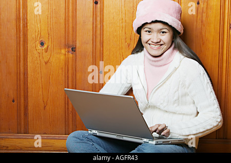 Young Woman with Laptop Smiling at Camera Stock Photo