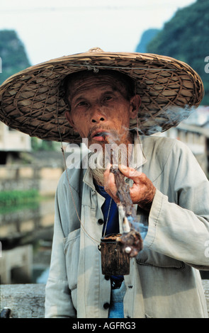 old man smoking pipe, Yangshuo, China Stock Photo