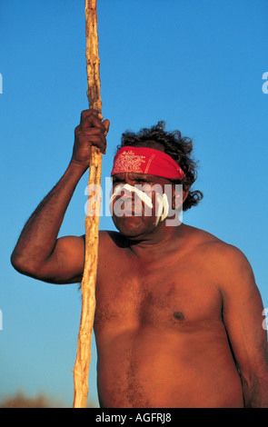 aboriginal with walking stick gazing at the sea, Darwin, Australia Stock Photo