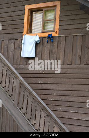 Detail of traditional old wooden house  in Polish countryside park outside Krakow with washing on line Stock Photo
