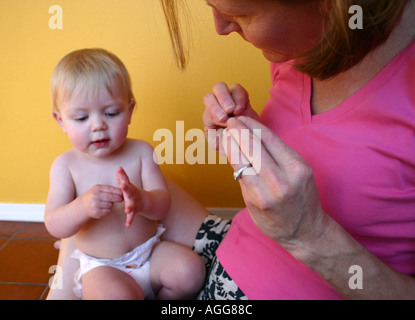 mother communicating with child using sign language Stock Photo