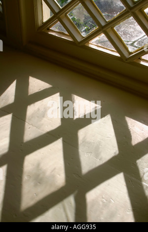 Window with shadow from diamond shaped panes Stock Photo