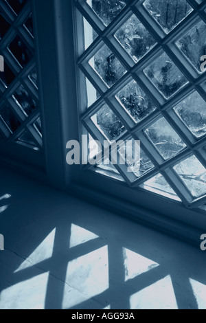 Window with shadow from diamond shaped panes Blue tone Stock Photo