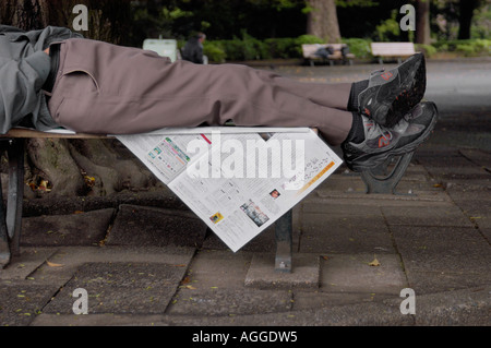 homeless man on park bench, Tokyo, Japan Stock Photo