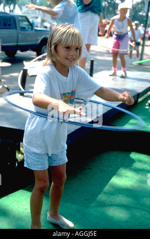 8 year old child Hula Hooping at Minnesota State Fair. St Paul Minnesota USA Stock Photo