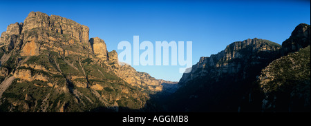 Europe Greece Epiros Vikos Aoös National Park Setting sun lights cliffs of Vikos Gorge from village of Vikos  Stock Photo