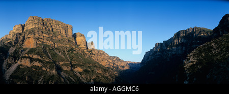 Europe Greece Epiros Vikos Aoös National Park Setting sun lights cliffs of Vikos Gorge from village of Vikos  Stock Photo