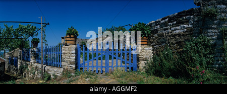 Europe Greece Epiros Vikos Aoös National Park Megalo Papingo Morning sun lights traditional stone house Stock Photo