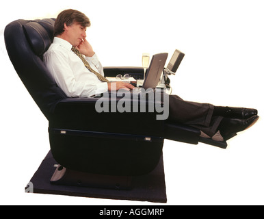 Businessman Traveling with Laptop in Premium Class seat Stock Photo