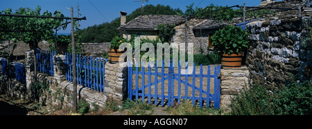 Europe Greece Epiros Vikos Aoös National Park Megalo Papingo Morning sun lights traditional stone house Stock Photo