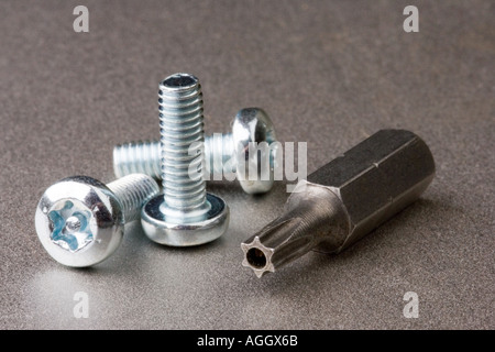 tamper proof security screws with a hexagon driver bit to install them Stock Photo