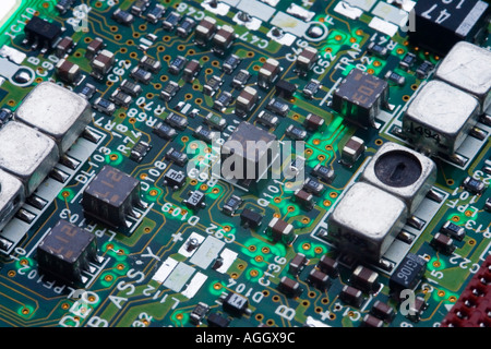 A circuit board showing various electronic components the construction is surface mount technology looking like a crowded city Stock Photo