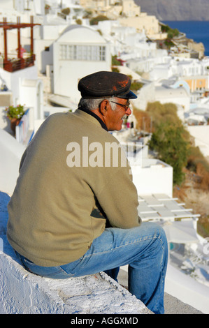 older man taking break from work, village of Oia, Santorini island, Greece Stock Photo