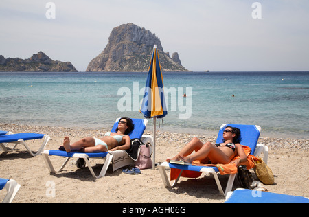 Women on deck chairs at the beach in Cala de Hort, Ibiza, Spain Stock Photo
