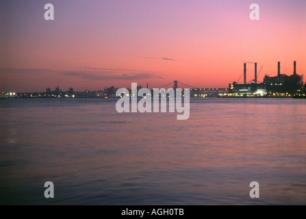 A view of the East river in New York City with the Con edison plant at East 14th Street at sunset. Stock Photo