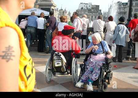 Disabled man and woman talking at the Liberty Festival, held in London September 2005 Stock Photo