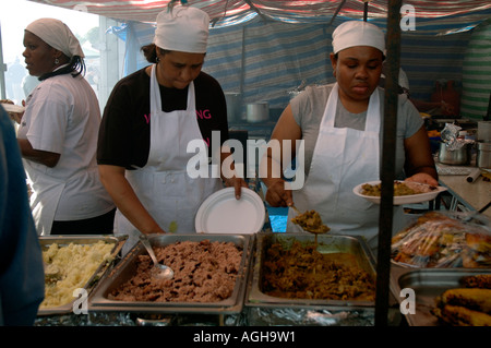 Women at Lambeth Country Fair serving up West Indian food. Stock Photo