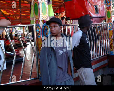 Group of youth hanging around Fun Fair at Lambeth Country Fair in Brockwell Park Brixton South London. Stock Photo