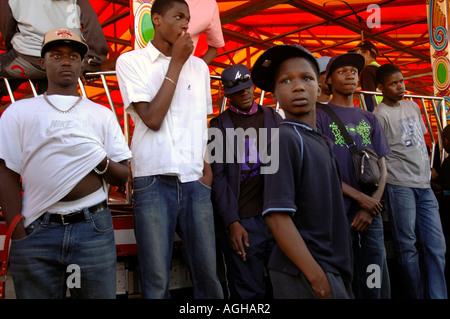 Group of youth hanging around Fun Fair at Lambeth Country Fair in Brockwell Park Brixton South London. Stock Photo
