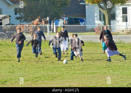 Children play school yard soccer at recess Amish life in Millersburg and Sugar Creek Holms County Ohio Stock Photo