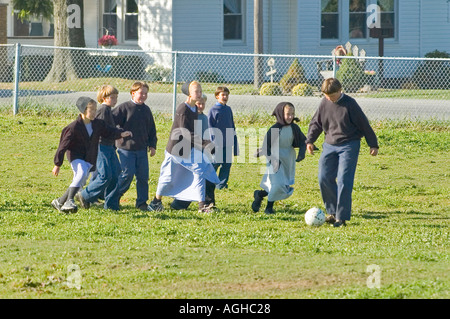 Children play school yard soccer at recess Amish life in Millersburg and Sugar Creek Holms County Ohio Stock Photo