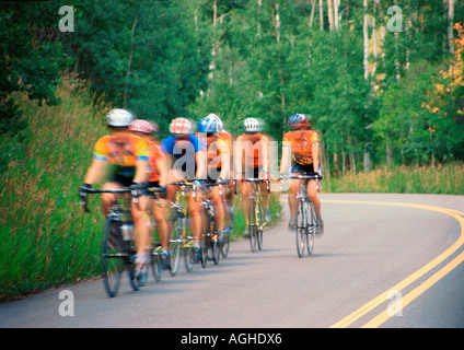 A group of cyclists riding down a highway Stock Photo