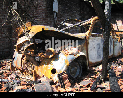 wreck of burnt out citroen 2CV in barn Stock Photo