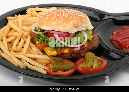 Hamburger with French Fries Beef burger on a plate American fast food overhead from above close up closeup pictures images horizontal in USA US hi res Stock Photo