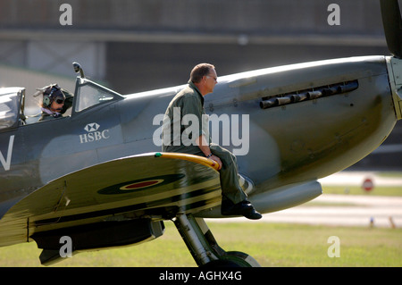 An aviatrix prepares for take off taxiing with a mechanic sitting on the wing of the Grace Spitfire.Picture by Jim Holden. Stock Photo