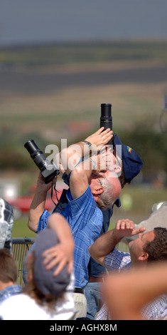 keen amateur photographers stretch their lenses to the sky as they try to snap aircraft at an airshow. Picture by Jim Holden. Stock Photo
