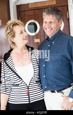 Close-up of a senior man standing with a mature woman and smiling Stock Photo
