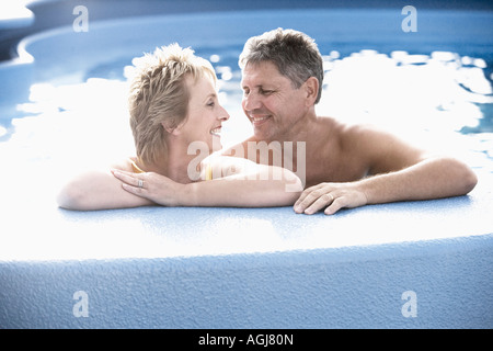 Mature woman and a senior man smiling in a swimming pool Stock Photo