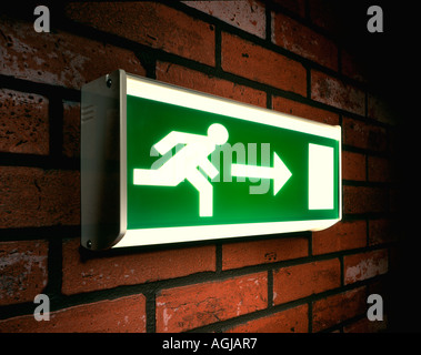 Running Man Emergency Exit sign on a brick wall