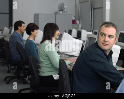 Mature students using computer Stock Photo