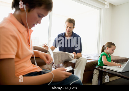 Family doing separate activities Stock Photo