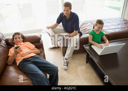 Family doing separate activities Stock Photo