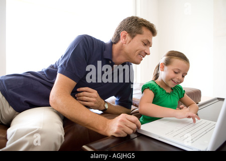 Father and daughter using laptop Stock Photo