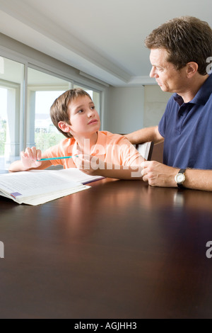Father helping son with homework Stock Photo