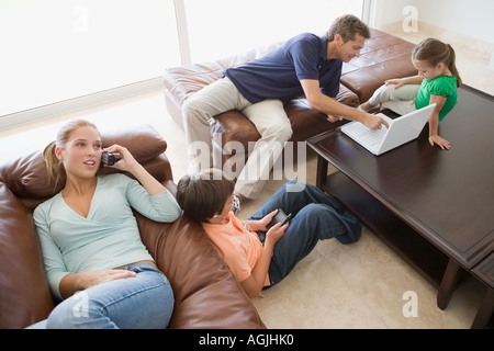 Family with different technologies Stock Photo