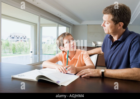 Father helping son with homework Stock Photo
