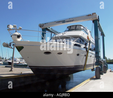 luxury boat in sling being launched Stock Photo